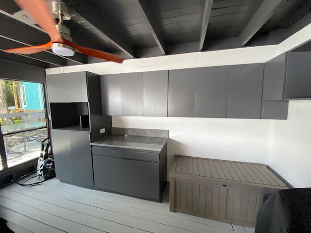 kitchen with beamed ceiling, gray cabinets, wood ceiling, and light hardwood / wood-style flooring