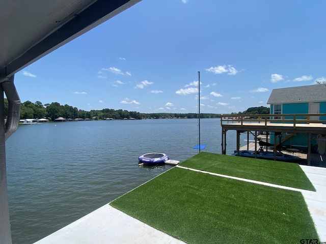 dock area with a yard and a water view