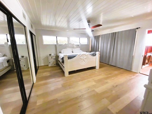 bedroom with light hardwood / wood-style flooring, ceiling fan, and wooden ceiling