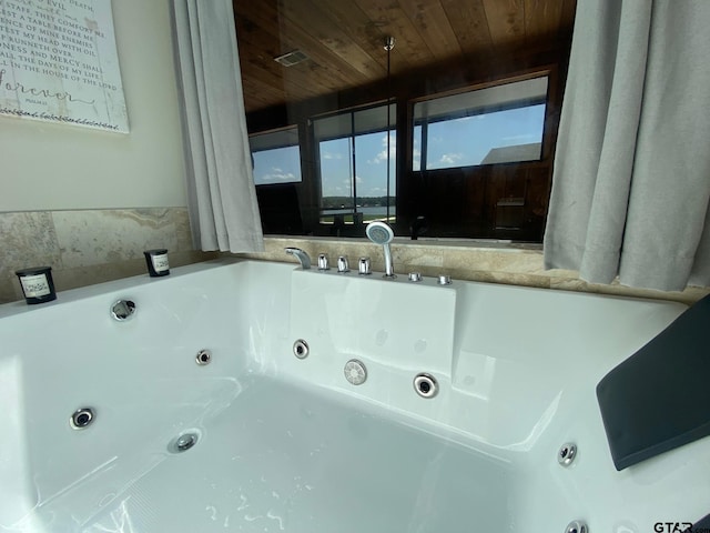 interior space with a bathtub and wood ceiling