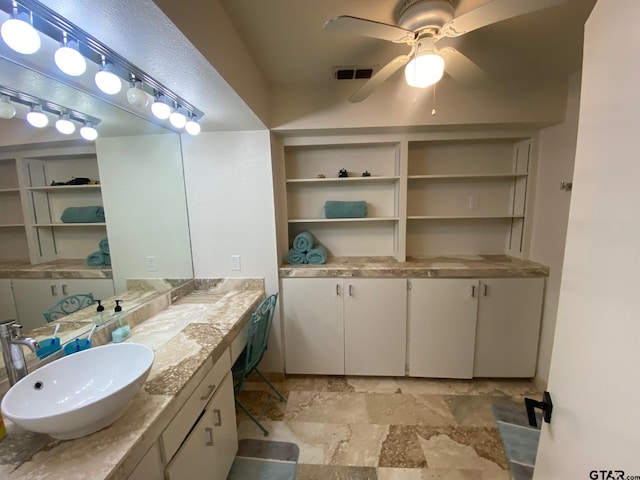 bathroom with ceiling fan and vanity