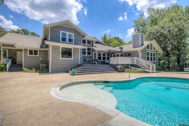 view of swimming pool featuring a patio and a deck