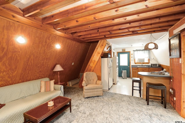 living room with beamed ceiling, radiator, baseboard heating, and wooden walls