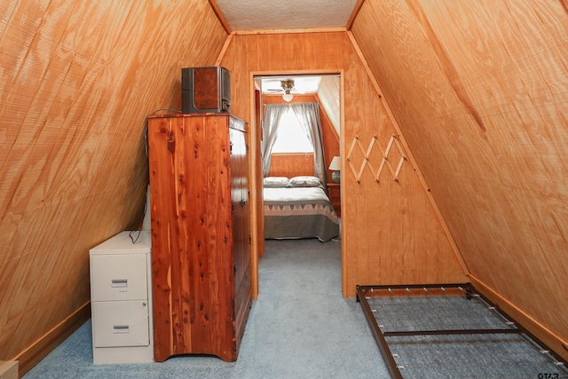 bonus room featuring wood walls, carpet floors, and lofted ceiling