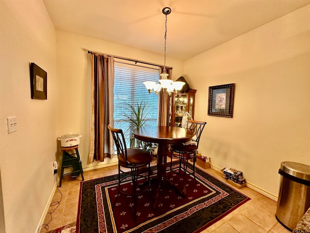 tiled dining area with a chandelier