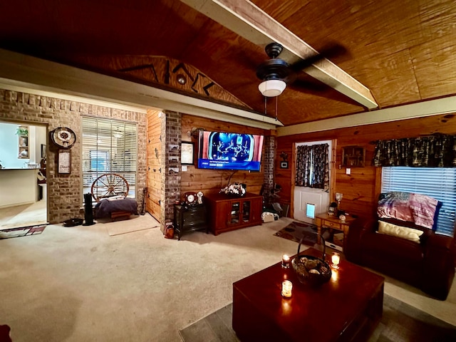 carpeted living room featuring wooden walls, wood ceiling, vaulted ceiling with beams, and ceiling fan