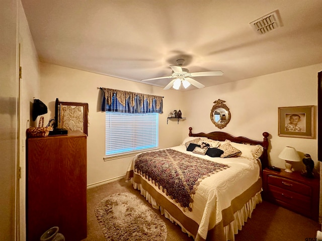 bedroom featuring ceiling fan and dark colored carpet