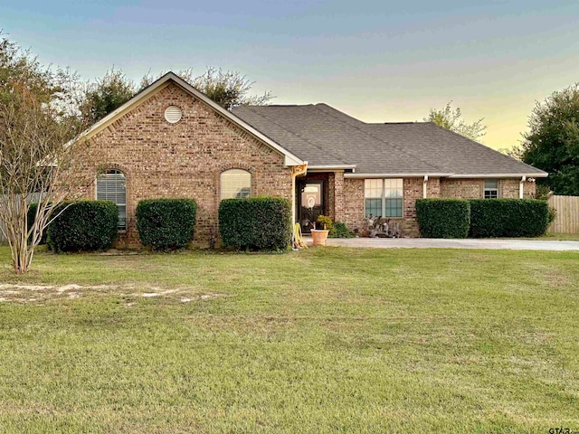 ranch-style house with a yard