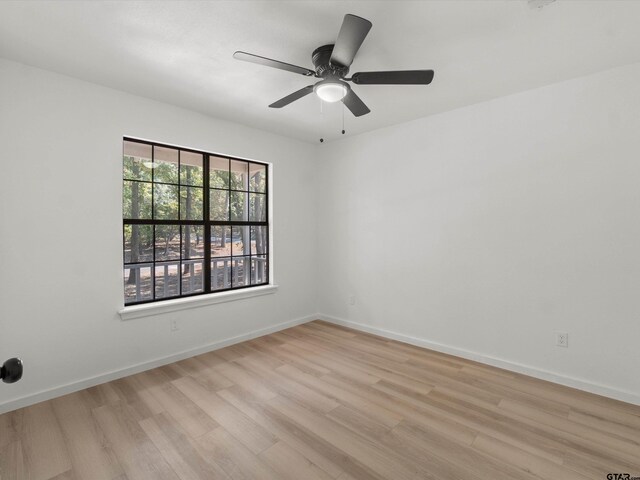 spare room featuring ceiling fan and light hardwood / wood-style flooring