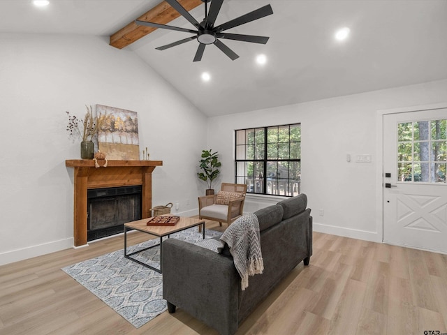 living room with high vaulted ceiling, light hardwood / wood-style flooring, ceiling fan, and beam ceiling