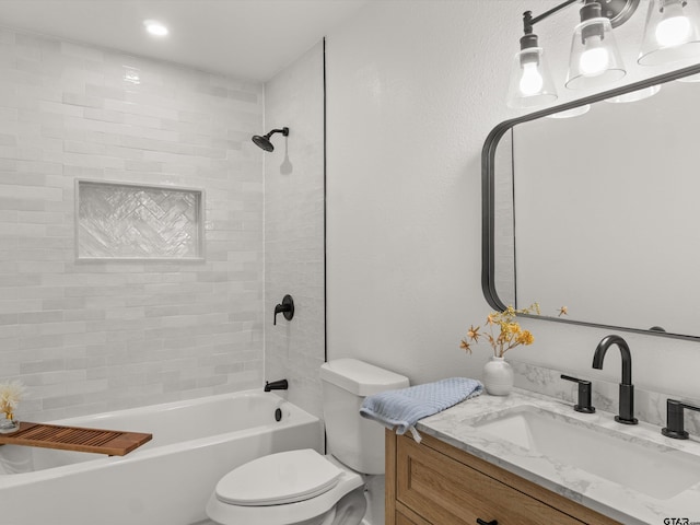 full bathroom featuring vanity, toilet, and tiled shower / bath combo