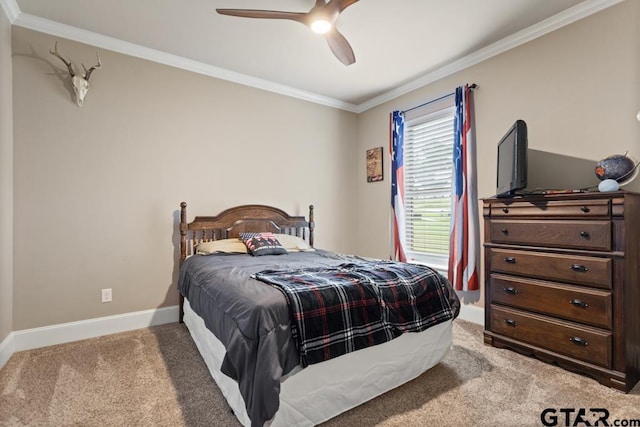 carpeted bedroom featuring ceiling fan and ornamental molding