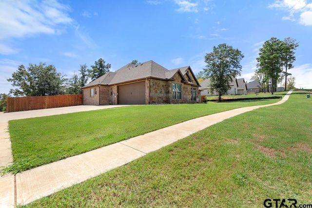 view of front of home featuring a front yard and a garage