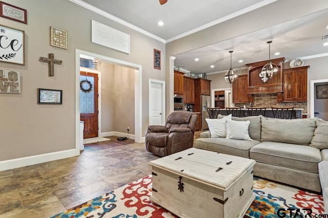 living room featuring ceiling fan with notable chandelier and crown molding