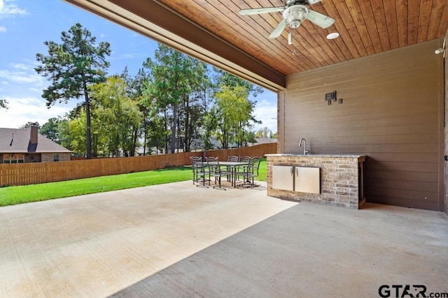 view of patio / terrace with ceiling fan and sink