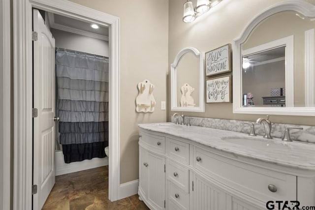 bathroom with toilet, vanity, and ornamental molding