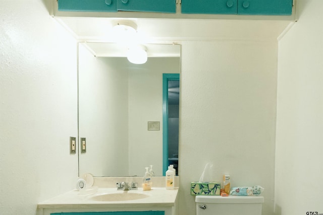 bathroom featuring toilet and vanity