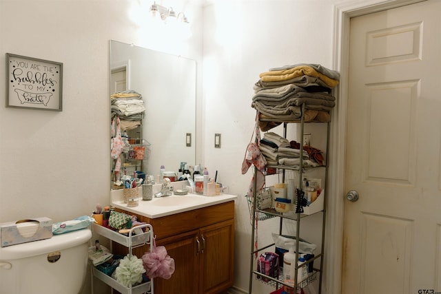 bathroom featuring toilet and vanity