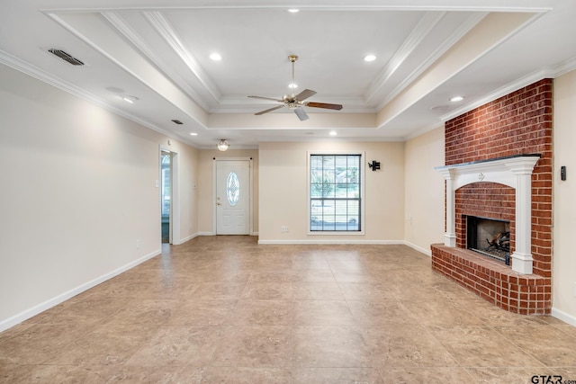 unfurnished living room with a raised ceiling, ceiling fan, a fireplace, and crown molding