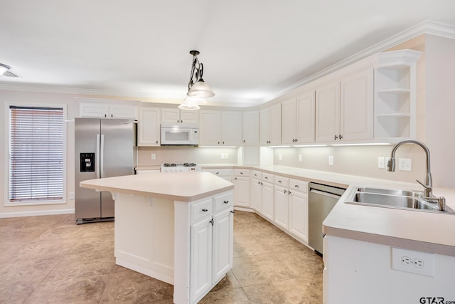 kitchen featuring a center island, sink, decorative light fixtures, white cabinetry, and stainless steel appliances