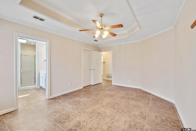 unfurnished bedroom featuring a tray ceiling, ceiling fan, and ornamental molding