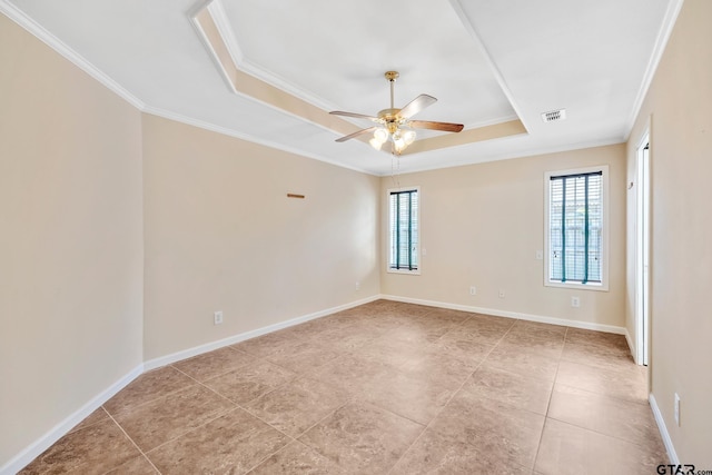 spare room featuring a raised ceiling, ceiling fan, and ornamental molding