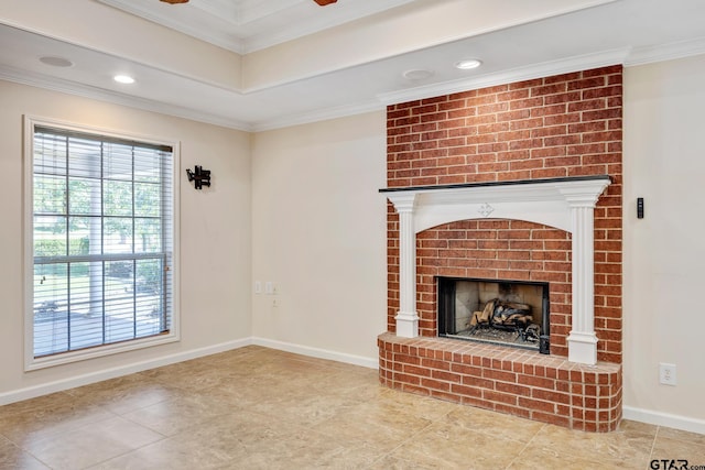 unfurnished living room with a raised ceiling, a fireplace, and ornamental molding