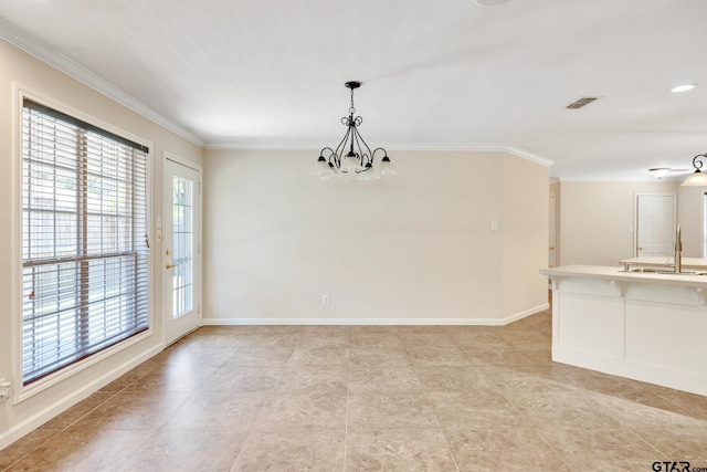 empty room featuring a chandelier, crown molding, and sink