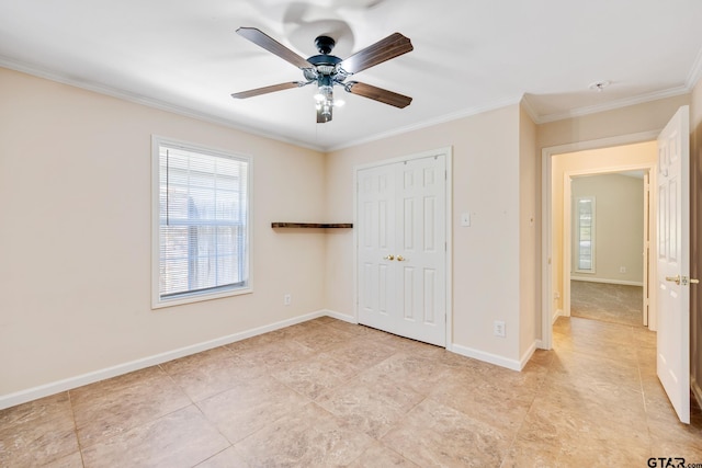 unfurnished bedroom with ceiling fan, ornamental molding, and a closet