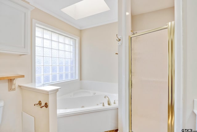 bathroom with independent shower and bath, ornamental molding, a wealth of natural light, and a skylight