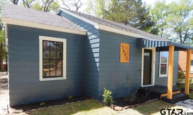 exterior space with a shingled roof