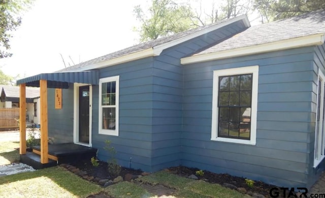 view of home's exterior with roof with shingles