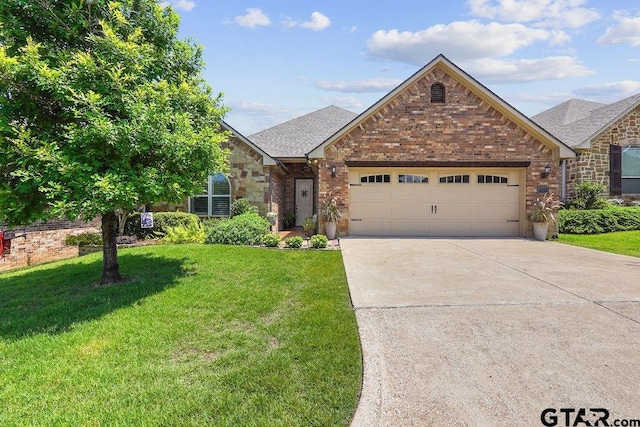 4133 Colina Trl, Tyler, TX 75707 - view of front facade featuring concrete driveway, a garage, a front yard, stone siding, and a shingled roof
