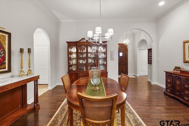 4133 Colina Trl, Tyler, TX 75707 - dining area with arched walkways, dark wood-style flooring, a chandelier, and ornamental molding