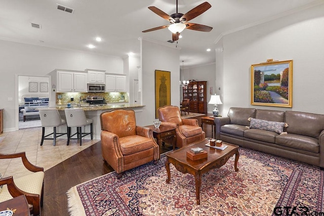 4133 Colina Trl, Tyler, TX 75707 - living area featuring crown molding, a ceiling fan, recessed lighting, and light tile patterned floors