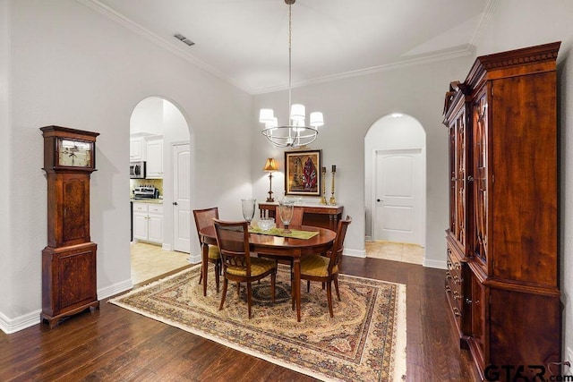 4133 Colina Trl, Tyler, TX 75707 - dining area featuring arched walkways, crown molding, hardwood / wood-style flooring, and a chandelier