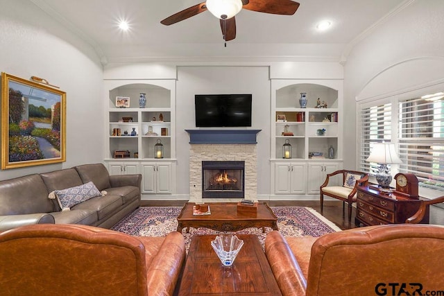 4133 Colina Trl, Tyler, TX 75707 - living room featuring built in features, crown molding, ceiling fan, a fireplace, and wood finished floors