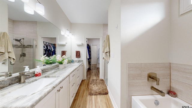 bathroom featuring vanity, shower with separate bathtub, and hardwood / wood-style floors