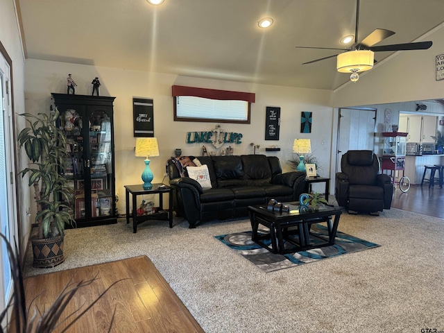 living room with lofted ceiling, hardwood / wood-style floors, and ceiling fan