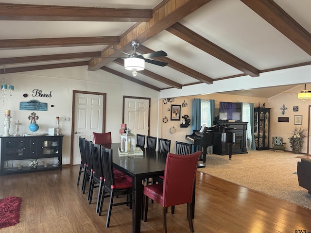 dining space with ceiling fan, dark hardwood / wood-style floors, and lofted ceiling with beams