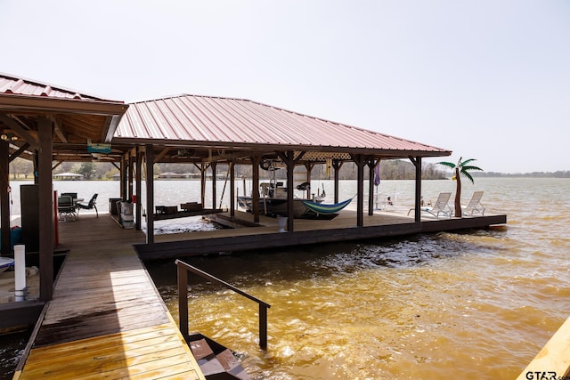 view of dock featuring a water view and boat lift
