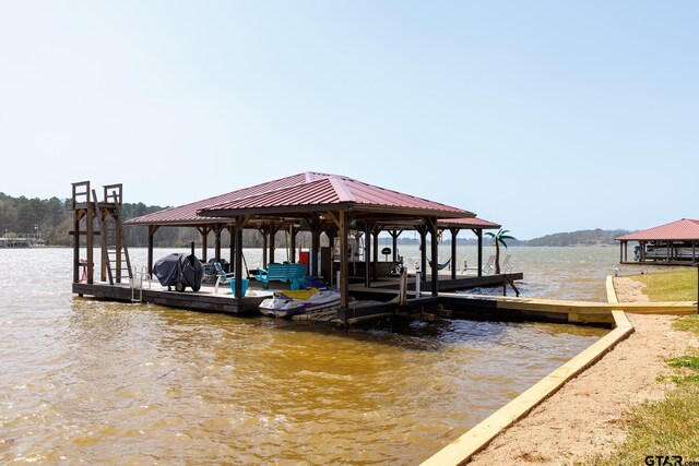dock area with a gazebo and a water view