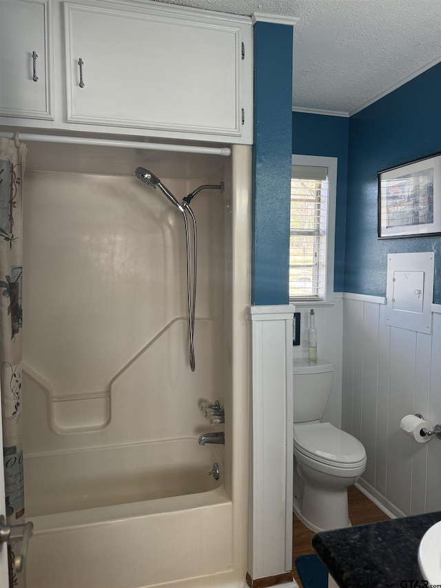 full bathroom with toilet, a textured ceiling, vanity, shower / bathtub combination with curtain, and hardwood / wood-style flooring