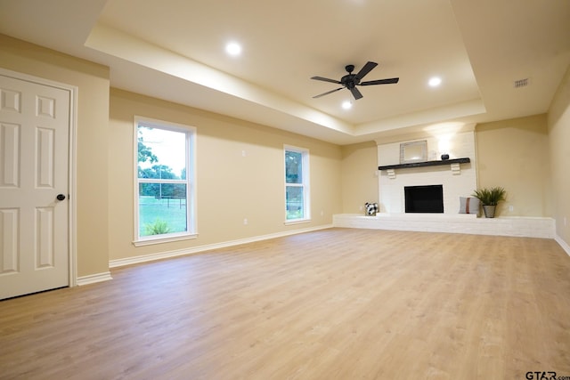 1370 Fm 315, Palestine, TX 75801 - unfurnished living room with a raised ceiling, wood finished floors, a fireplace, ceiling fan, and baseboards