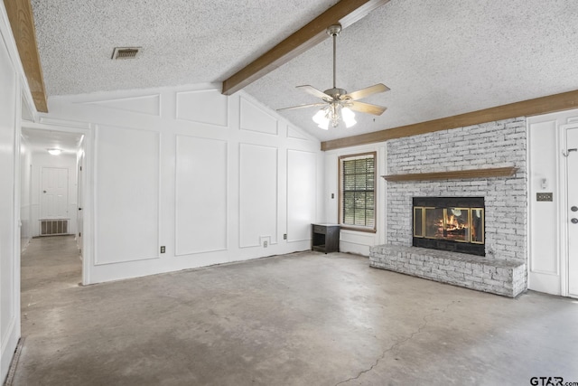 unfurnished living room featuring visible vents, concrete flooring, vaulted ceiling with beams, and a decorative wall