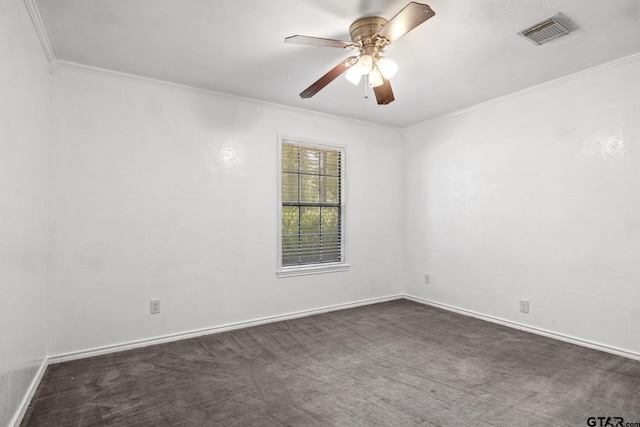 unfurnished room featuring visible vents, crown molding, dark colored carpet, baseboards, and ceiling fan