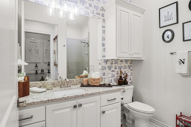 bathroom featuring vanity, toilet, and a shower with shower door