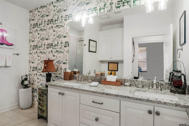 bathroom with tile patterned flooring, vanity, and walk in shower