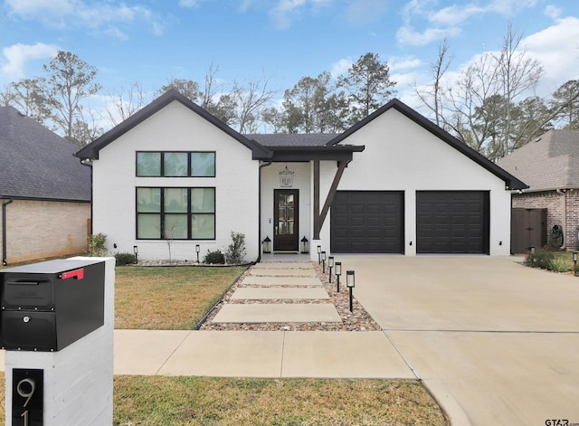 view of front of property featuring a front yard and a garage