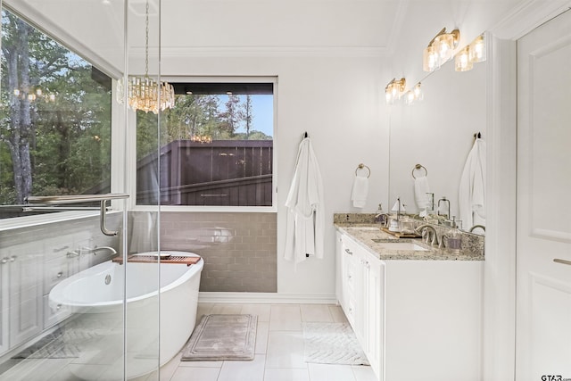 bathroom with vanity, a bath, crown molding, tile walls, and a notable chandelier